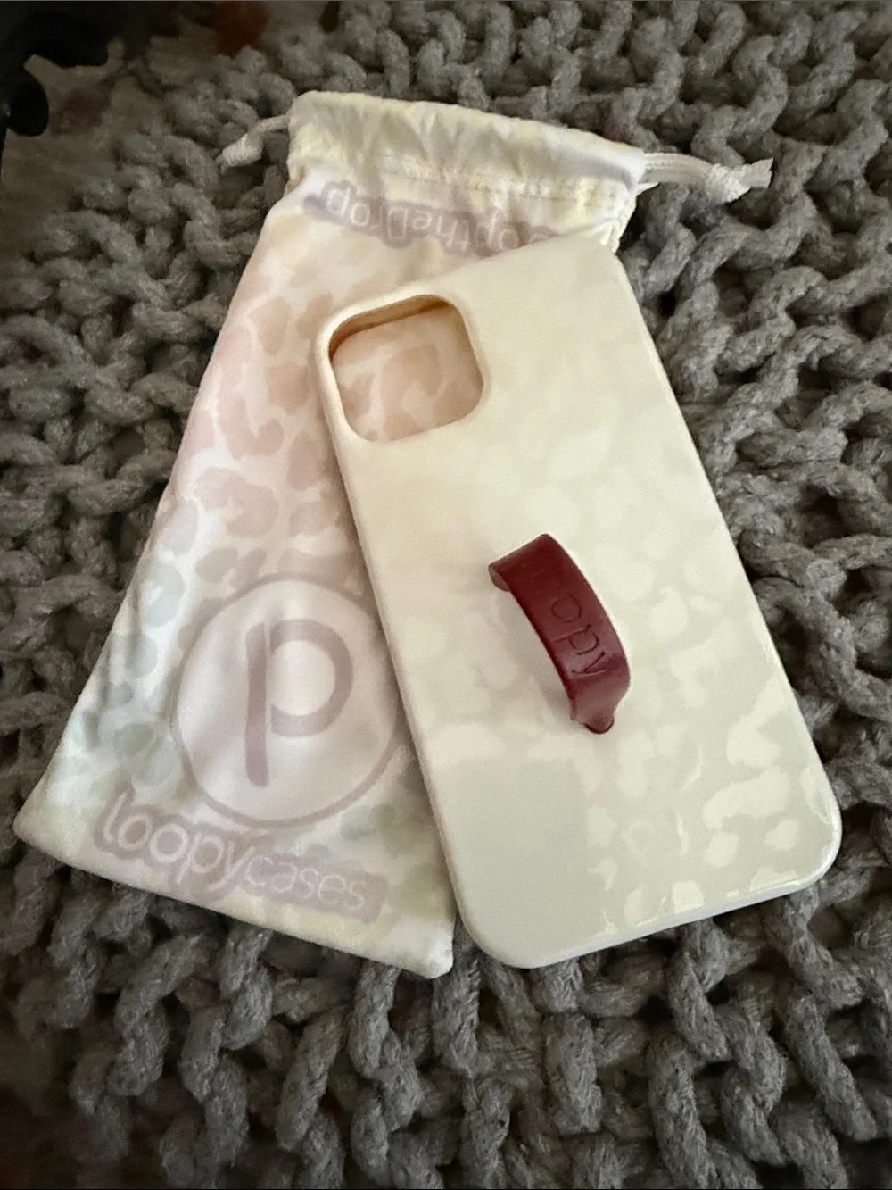 Loopy Case White Marble Phone Case with Burgundy Loopy Strap for IPhone 12 Pro.